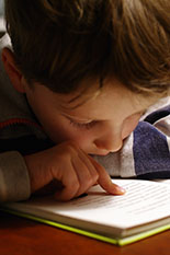 A boy reading a book.