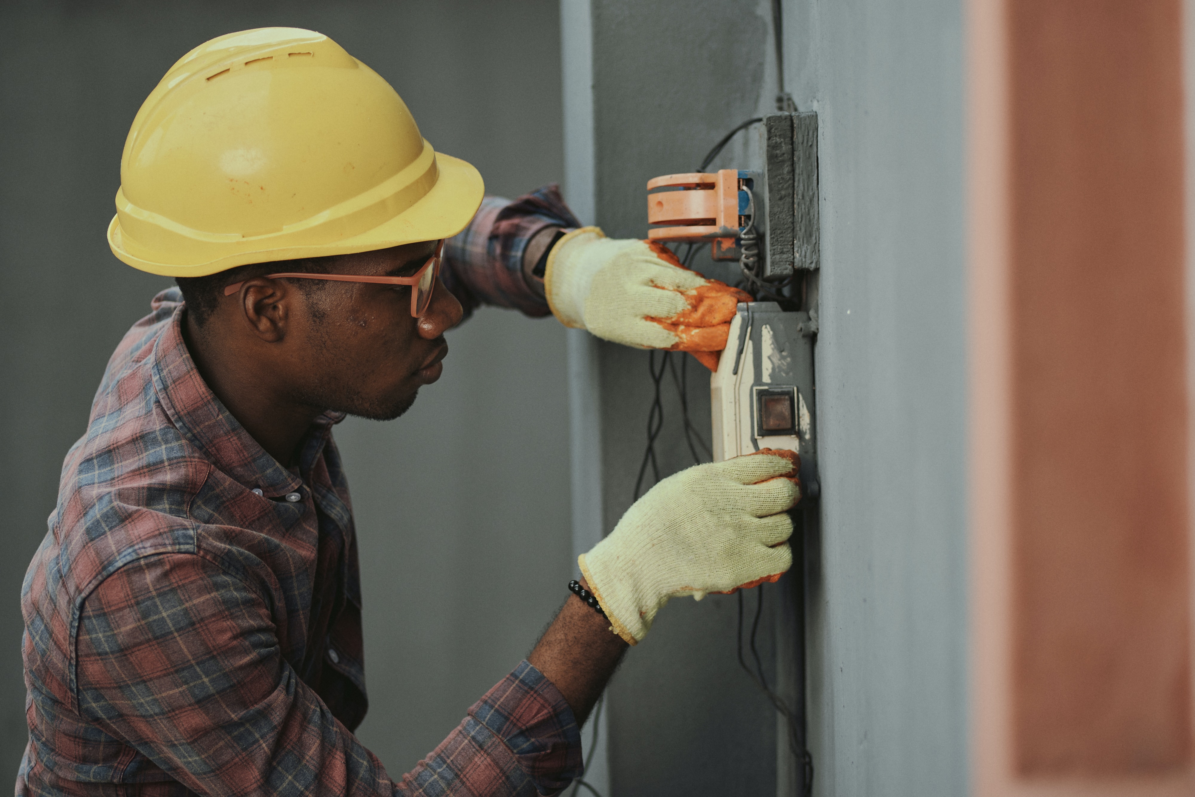 A man works at an electric junction box